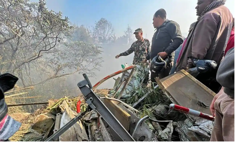 <strong>Rescuers gather at the site of the plane crash in Pokhara. Photograph: Krishna Mani Baral/AFP/Getty Images</strong>